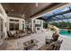 The outdoor living area offers comfortable seating and a fireplace, with views of the pool at 18521 Wayne Rd, Odessa, FL 33556