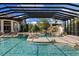 A custom pool features a waterfall, slide, and sun deck within a screened enclosure at 18521 Wayne Rd, Odessa, FL 33556