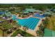 Aerial view of community pool features lap lanes, splash area, water slide, and lush landscaping at 19206 Ivy Oak Way, Tampa, FL 33647