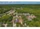 Aerial view showcasing property, nearby neighborhood, and a densely wooded area in the background, ideal for privacy at 19206 Ivy Oak Way, Tampa, FL 33647