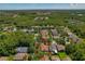Overhead image displays the home situated within a neighborhood, surrounded by abundant trees, and a tranquil pond nearby at 19206 Ivy Oak Way, Tampa, FL 33647