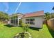 The house has a lush backyard with a covered patio and a sunroom, great for outdoor living at 19206 Ivy Oak Way, Tampa, FL 33647
