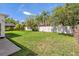 Large backyard with a green lawn and trees, ideal for outdoor activities and enjoying the surrounding nature at 19206 Ivy Oak Way, Tampa, FL 33647