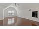 This spacious bedroom features wood floors, a ceiling fan, and a built-in shelf for added storage at 19206 Ivy Oak Way, Tampa, FL 33647