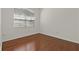 Bright bedroom with hardwood flooring, trim, and natural light from the window at 19206 Ivy Oak Way, Tampa, FL 33647