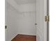 Walk-in closet with rod and wire shelving, hardwood floors, and white walls at 19206 Ivy Oak Way, Tampa, FL 33647