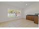 Bright dining area with tile floor, large window and built in cabinets with counter at 19206 Ivy Oak Way, Tampa, FL 33647