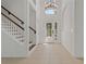 Bright foyer with high ceilings, tile floors, and an elegant staircase at 19206 Ivy Oak Way, Tampa, FL 33647