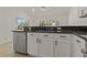 Bright kitchen features stainless steel appliances, white cabinets and dark granite countertops at 19206 Ivy Oak Way, Tampa, FL 33647