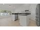 Open kitchen with stainless steel appliances, white cabinets and center island at 19206 Ivy Oak Way, Tampa, FL 33647