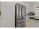 Stainless steel refrigerator featured in the kitchen with white cabinets and granite counters at 19206 Ivy Oak Way, Tampa, FL 33647