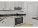 Kitchen featuring stainless steel appliances, white cabinets, and tile flooring at 19206 Ivy Oak Way, Tampa, FL 33647
