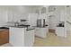 Open kitchen with white cabinets, stainless steel appliances, and a breakfast bar at 19206 Ivy Oak Way, Tampa, FL 33647