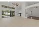 Living area with tile floors, ceiling fan, large glass doors, and a view of the kitchen at 19206 Ivy Oak Way, Tampa, FL 33647