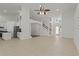 Open-concept living area with tile flooring, high ceilings, and a view of the kitchen at 19206 Ivy Oak Way, Tampa, FL 33647