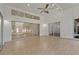 Spacious living room with laminate floors, a ceiling fan, high ceilings with glass panels, and sliding glass doors at 19206 Ivy Oak Way, Tampa, FL 33647