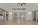 Open living room boasts high ceilings, laminate floors, and sliding glass doors that allow natural light to fill the space at 19206 Ivy Oak Way, Tampa, FL 33647