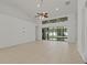Spacious living room featuring tile floors, a ceiling fan, and sliding glass doors at 19206 Ivy Oak Way, Tampa, FL 33647