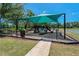 Community playground features a covered play structure with slides, climbing areas, and soft ground covering at 19206 Ivy Oak Way, Tampa, FL 33647