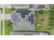 Drone's eye view of solar panels on roof; lush, landscaped backyard with patio, greenery, and privacy fence at 2073 Branding Iron Way, New Port Richey, FL 34655