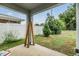 A covered back porch with view of the backyard with a privacy fence at 2073 Branding Iron Way, New Port Richey, FL 34655