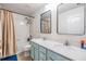 Bright bathroom featuring double sinks, bathtub with shower, and neutral tile flooring at 2073 Branding Iron Way, New Port Richey, FL 34655