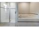 Bathroom showcasing a shower and a separate bathtub with tile surround at 2073 Branding Iron Way, New Port Richey, FL 34655