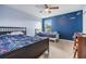 Stylish bedroom with two beds, blue walls, and fun decor, perfect for a shared space at 2073 Branding Iron Way, New Port Richey, FL 34655