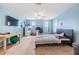 Bright bedroom with carpet flooring, large windows, and a ceiling fan at 2073 Branding Iron Way, New Port Richey, FL 34655