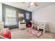 Cozy Bedroom with a crib, playful decor, and ample natural light, perfect for a young  at 2073 Branding Iron Way, New Port Richey, FL 34655