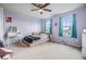Bright, comfortable bedroom with two windows, a ceiling fan, and a cozy bed for relaxation at 2073 Branding Iron Way, New Port Richey, FL 34655
