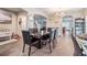 Inviting dining room with wood-look tile floors and a modern chandelier, perfect for Gathering gatherings at 2073 Branding Iron Way, New Port Richey, FL 34655