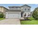 Beautiful two-story home with a two-car garage, well-maintained landscaping, and a welcoming entrance at 2073 Branding Iron Way, New Port Richey, FL 34655