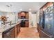 A spacious kitchen with wood floors, granite countertops, stainless steel appliances, and ample cabinet space at 2073 Branding Iron Way, New Port Richey, FL 34655