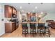 Modern kitchen with stainless appliances, granite counters, and a breakfast bar overlooking the living area at 2073 Branding Iron Way, New Port Richey, FL 34655