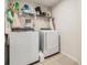 Functional laundry room featuring a washer, dryer, and ample storage space for laundry essentials at 2073 Branding Iron Way, New Port Richey, FL 34655