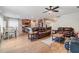 Open-concept living room with tile floors, comfortable seating, and seamless flow to the kitchen area at 2073 Branding Iron Way, New Port Richey, FL 34655