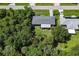 Aerial view of a charming home nestled among lush trees and manicured lawns at 22442 Vale Ave, Punta Gorda, FL 33980