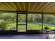 Screened-in patio with backyard view of swing set and green grass at 22442 Vale Ave, Punta Gorda, FL 33980