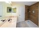 Bathroom featuring wood-look tile, a glass enclosed shower, a spacious vanity, and modern fixtures at 22442 Vale Ave, Punta Gorda, FL 33980