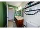 Bathroom with neutral tile flooring, vanity and decor shelf at 22442 Vale Ave, Punta Gorda, FL 33980