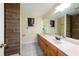 Bathroom featuring modern wood-look tiling in the shower, a large vanity, and ample lighting at 22442 Vale Ave, Punta Gorda, FL 33980