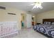 Bright bedroom with a bed, baby crib, and a doorway to a bathroom, offering a versatile living space at 22442 Vale Ave, Punta Gorda, FL 33980