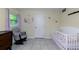 Adorable Bedroom with a crib, rocking chair, and charming wall decor, creating a warm and inviting space at 22442 Vale Ave, Punta Gorda, FL 33980