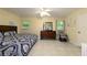 Well-lit bedroom with neutral walls, tile flooring, and a large dresser with a mirror at 22442 Vale Ave, Punta Gorda, FL 33980