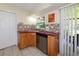 Kitchen area with tile backsplash, plenty of counter space, a dishwasher, and a convenient layout at 22442 Vale Ave, Punta Gorda, FL 33980