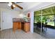 Cozy kitchen featuring wooden cabinets, stainless steel appliances, and a sliding glass door to the outdoor patio at 22442 Vale Ave, Punta Gorda, FL 33980