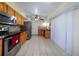 Well-lit kitchen featuring stainless steel appliances, wooden cabinets, and easy-to-clean tile floors at 22442 Vale Ave, Punta Gorda, FL 33980