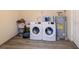 Laundry room with washer, dryer, water heater, and tile flooring at 22442 Vale Ave, Punta Gorda, FL 33980
