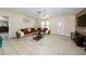 Open living room showcasing tile floors, a fan, a modern sectional sofa, and plenty of natural light at 22442 Vale Ave, Punta Gorda, FL 33980